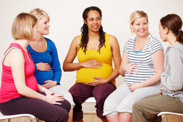 Discussing their hopes and dreams. A group of pregnant women sitting down together to share their...