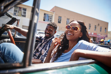 Its not about the destination, its about the ride. A happy young couple driving in a convertible on...