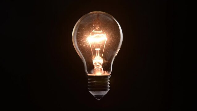 tungsten light bulb lighten on black background