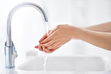 Keeping hands clean. Shot of hands being washed at a tap.