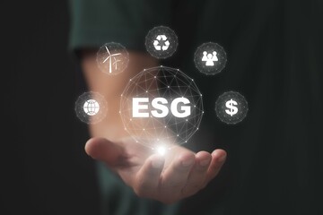 ESG concept in the hand for environmental, social, and governance in sustainable on the Network connection.