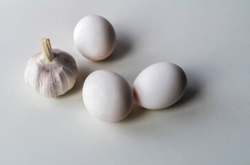 Fresh chicken eggs and garlic head
