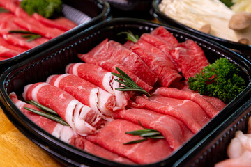 Beef shabu slides in a plastic box. for takeout order put it on the dining table

