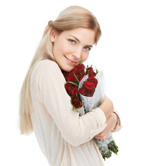 Red roses for a blonde beauty. A young woman standing isolated on white holding a bunch of red roses.