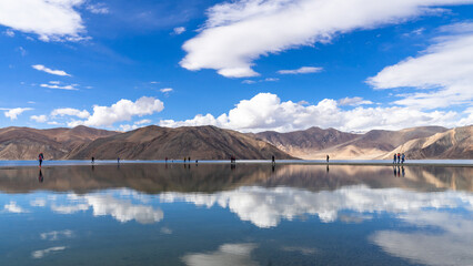 Pangong Tso or Pangong Lake landscape reflections of the mountains and blue sky on the lake, Leh Ladakh, Northern India,  situated on the border with India and China.