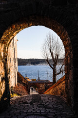 Oslo, Norway March 3, 2022 A view inside the Akershus Festning, or Akerhus fortress in central Oslo, and an archway pointing towards the sea.