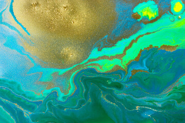 Gold spots on flow blue and green wave paints abstract background