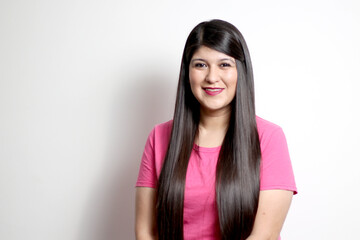 Latin adult woman poses for the camera showing her long straight black hair, healthy, shiny and silky hair looks happy and excited an overweight model body positive
