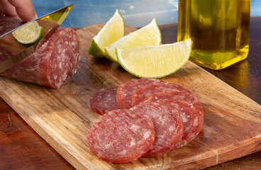 Delicious Italian salami with pieces of lemon. Selective focus.