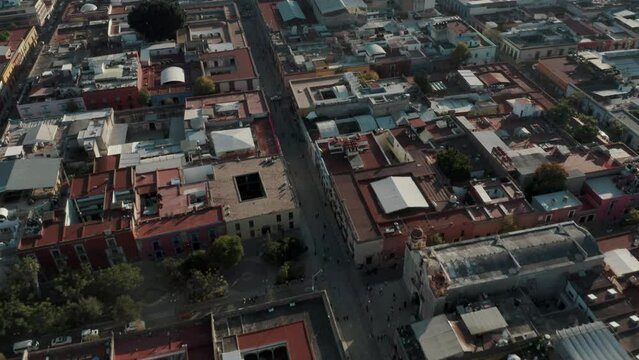 Fly Over Downtown And Templo de Santo Domingo With Mountain Backdrop In Oaxaca, Mexico. Aerial Drone Shot