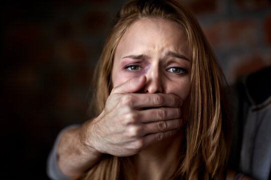 Silent destroyer. Abused young woman being silenced by her abuser.