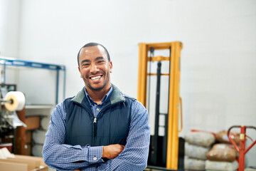 My factory floor is a well-oiled machine. Portrait of a smiling factory worker.