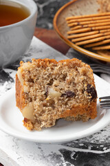 A piece of nuts cake on white plate. Selective focus.