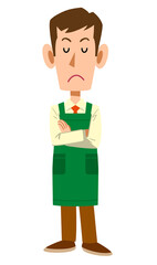 腕組みをして考えるスーパーマーケットの男性店員
