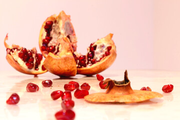 Pomegranate grains scattered on the table, blurred background