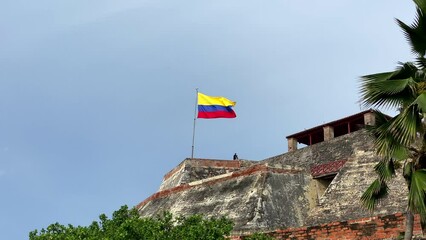 Raised Colombian flag at the San Felipe Castle in Cartagena Colombia