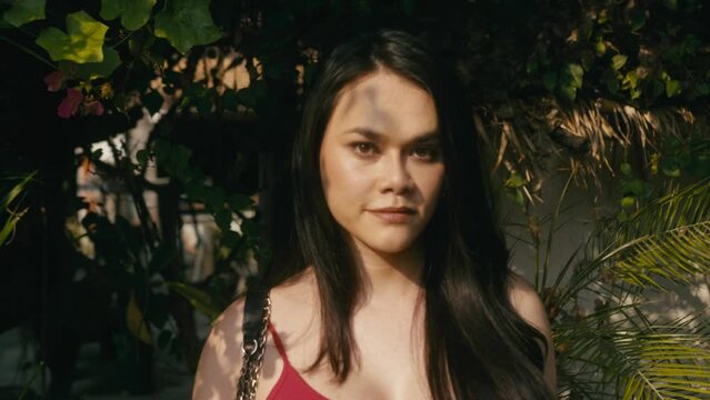 a beautiful trans woman looks at camera