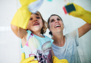 Making chores fun. Shot of a mother and daughter doing chores together at home.