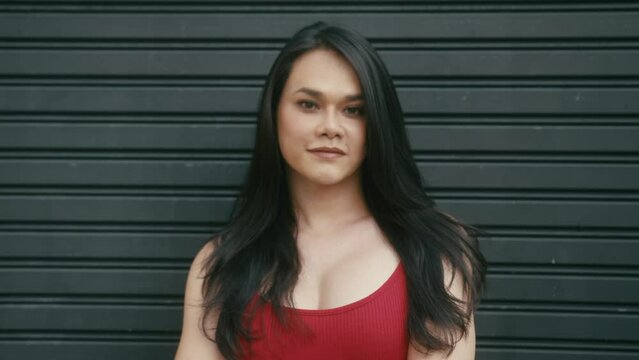 a beautiful trans woman looks at camera