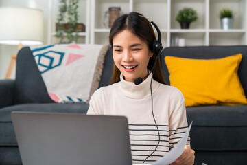 Woman consultant wearing microphone headset of customer support phone operator at home office.