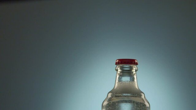 Close up video of the openning the bottle with soda water with bubbles in slow motion, 4k Prores HQ 120 fps