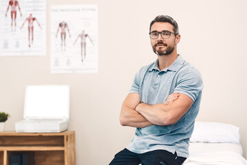 Helping you heal is my job. Portrait of a handsome mature male physiotherapist posing with his arms...
