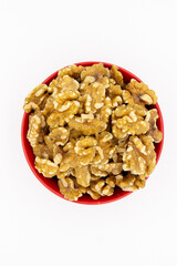 Peeled walnuts in red plate