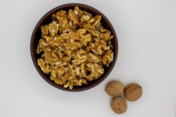 Peeled walnuts in brown plate