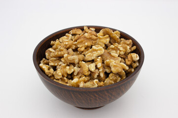 Peeled walnuts in brown plate