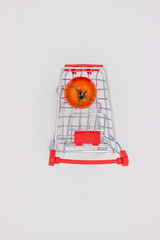 Fototapeta na wymiar Tomatoes in metal basket on white background