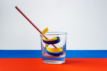 Blue and yellow ribbons as symbol of Ukraine in glass on flag of Russia.Russia want to drink Ukraine