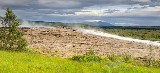 Geysir spring with steam in iceland, natural hot spring area