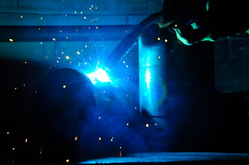 Welding of steel, sparking. Sparks from welding. Welding of pipes.