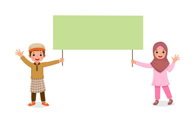 happy little muslim kids boy and girl waving hands while holding blank billboard sign for copyspace advertising and announcement messages