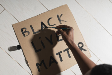 Black lives matter and fight against racism and write sign and words on cardboard - protest concept...