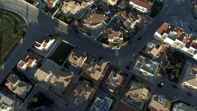 Aerial top down view over suburbs Portuguese neighborhood, single family homes cul-de-sac layout streets