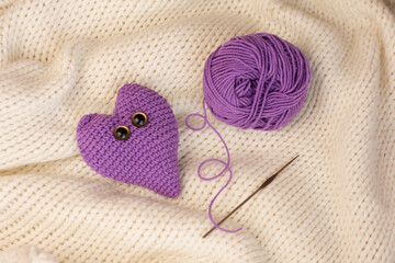 knitted heart on a fabric