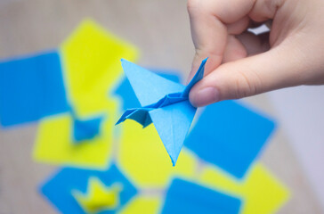 a crane made of paper, a symbol of peace in Ukraine, no war, children's creativity