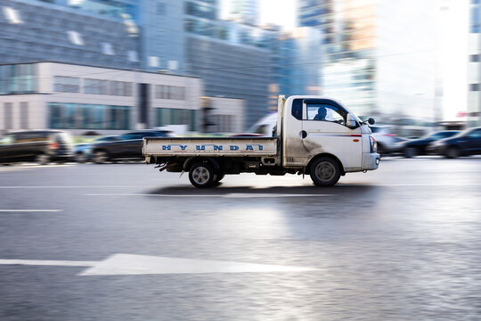 Hyundai H-100 Cargo Flatbed Truck In The City Street. Hyundai Porter 2 In Fast Motion With Blurred Background