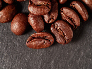 Coffee beans. On a black background. Top view. Space for copying.