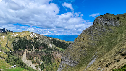 Fototapeta na wymiar Mountain peak of Hahnkogel (Klek) with panoramic view in spring in the Karawanks, Carinthia, Austria. Borders Austria, Slovenia, Italy. Triglav National Park. Alpine meadows. Alm. Snow fields melting