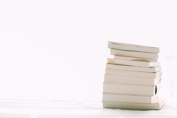 Books piled up on the desk.