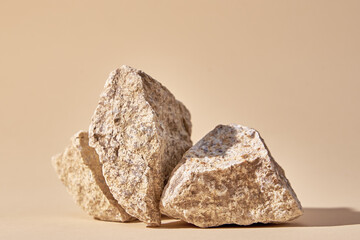 Natural granit stone on beige background, minimal product podium - obrazy, fototapety, plakaty
