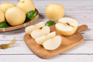 Chinese pear with cut in half on white table. Clipping path.
