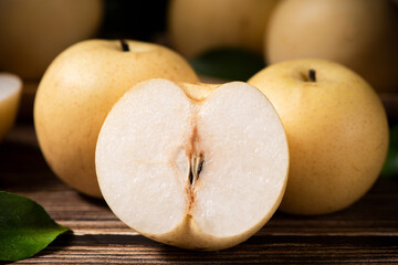 Chinese pear with cut in half on wooden table. 