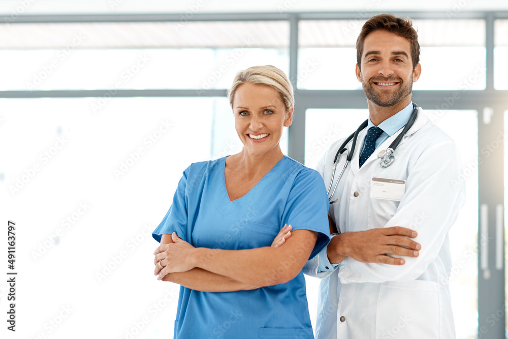 Poster You can put your confidence in us. Cropped portrait of two happy healthcare practitioners standing with their arms folded in the hospital.