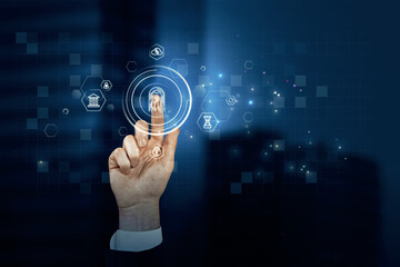 Close up of businessman hand pointing at abstract glowing id fingerprint web protection and security interface on blurry blue bokeh city background. Identification, cybersecurity and privacy concept. 