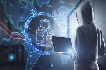 Hacker in hoodie using laptop computer with abstract digital padlock and map hologram on blurry...