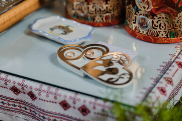 A pair of gold wedding rings on a heart-shaped stand. wedding ceremony