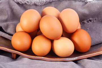 many eggs are placed on a ceramic tray.